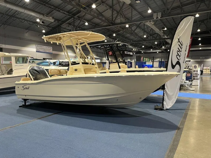 Slide: The Image of 2024 Scout 195 SF boat displayed at an indoor boat show. - 1