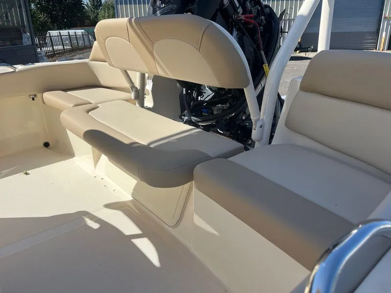 Slide: The Image of 2024 Scout 195 SF boat interior with beige cushioned seating. - 11