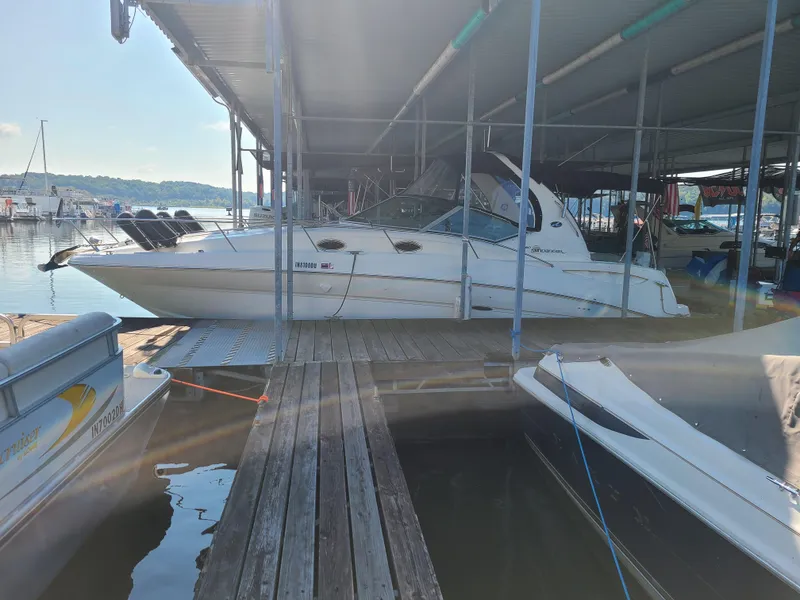 Slide: The Image of 2002 Sea Ray 320 Sundancer docked at a marina under a covered slip. - 22