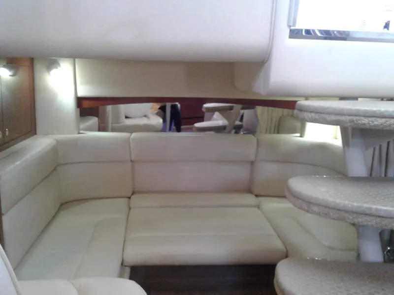 Slide: The Image of Interior of 2002 Sea Ray 320 Sundancer with beige leather seating and steps. - 44