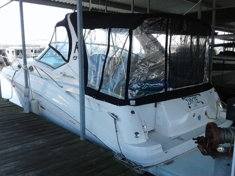 Slide: The Image of 2002 Sea Ray 320 Sundancer boat docked with black canopy. - 9