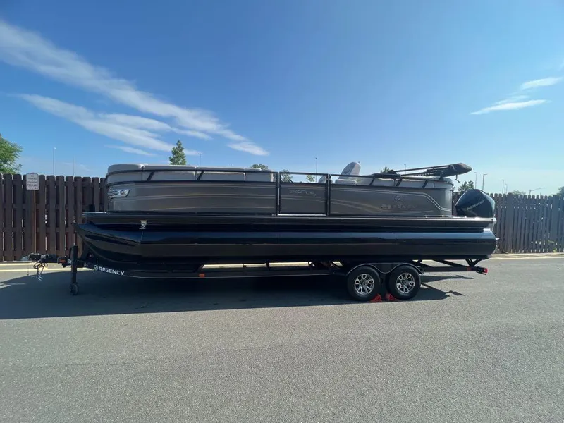 The Image of 2023 Regency 250 LE3 pontoon boat on a trailer. - 0