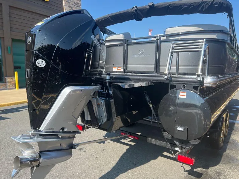 Slide: The Image of 2023 Regency 250 LE3 pontoon boat with powerful outboard motor. - 2