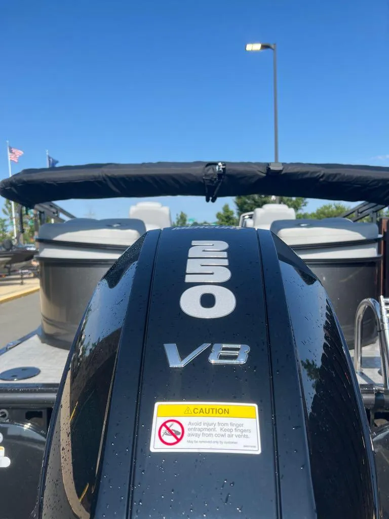 Slide: The Image of 2023 Regency 250 LE3 boat with V8 engine under clear blue sky. - 3