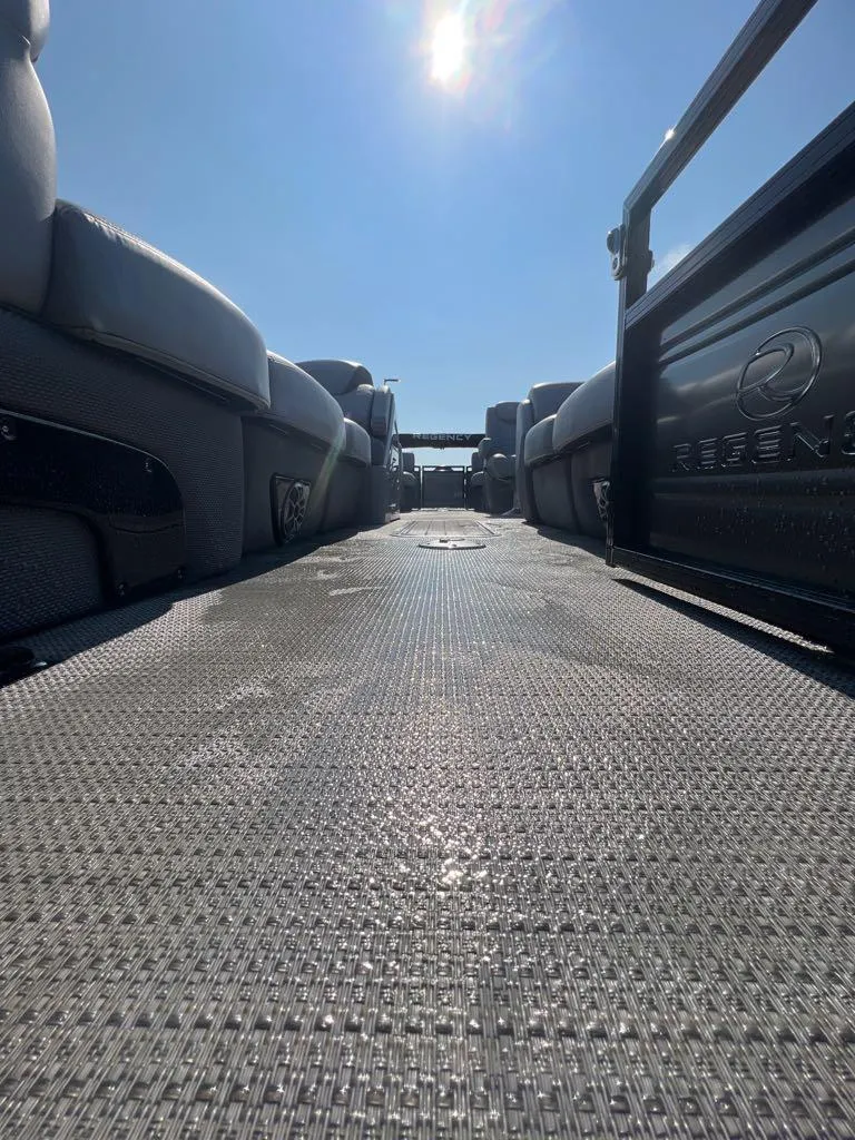 Slide: The Image of 2023 Regency 250 LE3 pontoon boat interior under sunny sky. - 5