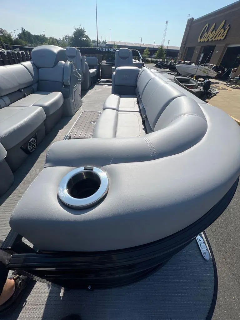 Slide: The Image of 2023 Regency 250 LE3 pontoon boat with luxurious seating at Cabela's. - 6