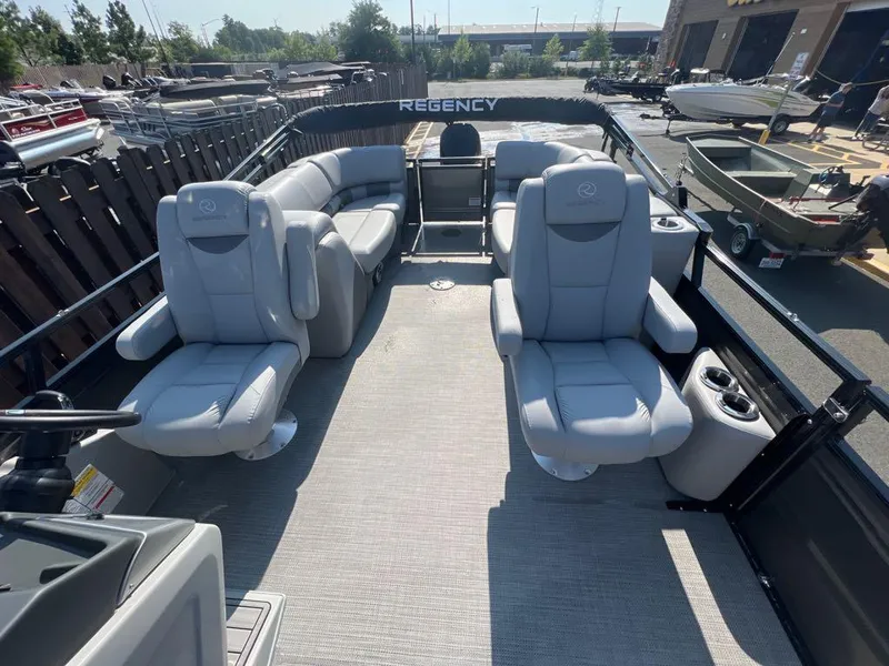 Slide: The Image of 2023 Regency 250 LE3 pontoon boat interior with luxurious seating. - 7
