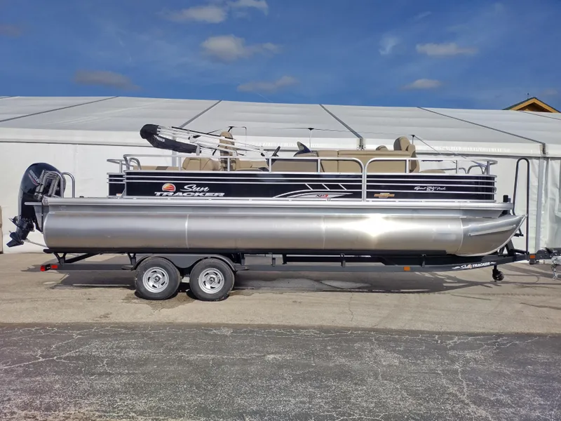 Slide: The Image of 2023 Sun Tracker Sportfish 24 XP3 pontoon boat on trailer. - 2