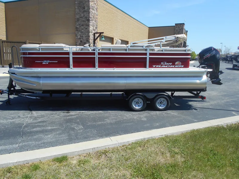 Slide: The Image of 2024 Sun Tracker Party Barge 22 RF DLX pontoon boat on trailer. - 2