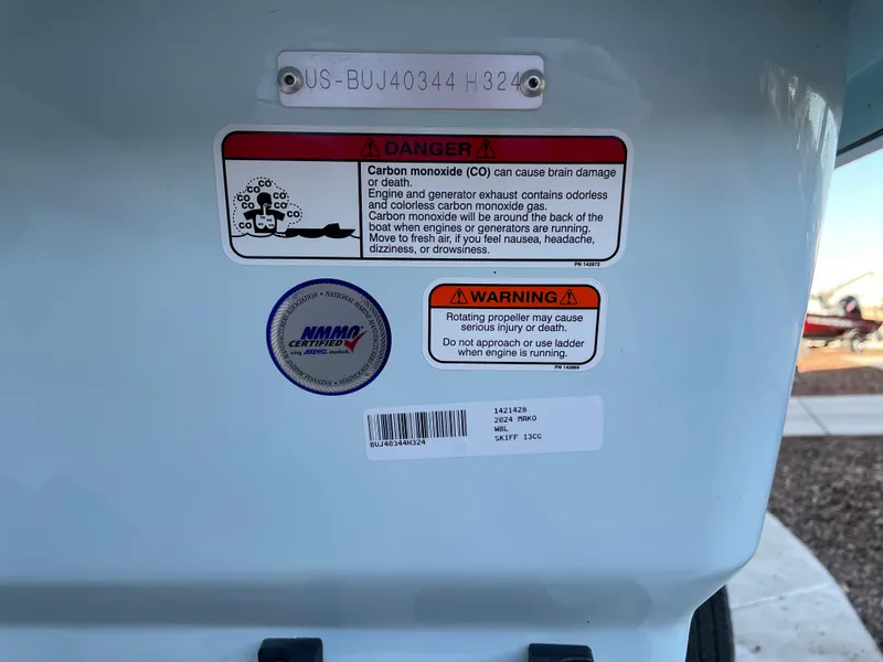 Slide: The Image of 2024 Mako Pro Skiff 13 CC warning labels and serial number plate. - 7