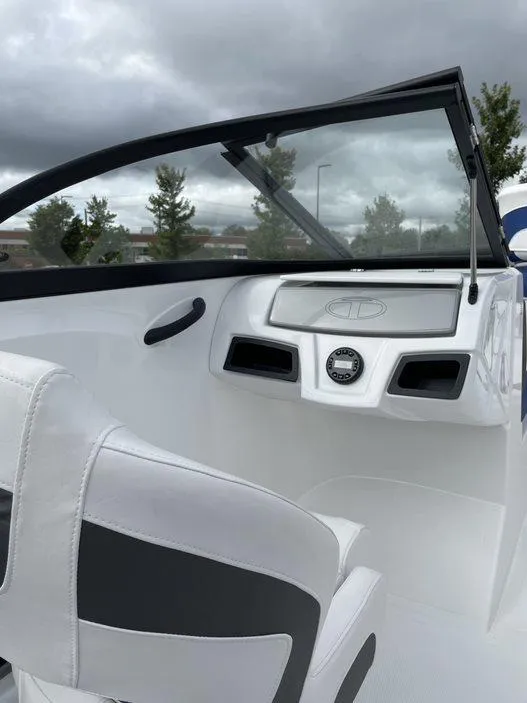 Slide: The Image of 2024 Tahoe 185 S boat interior with steering console and white seating. - 3