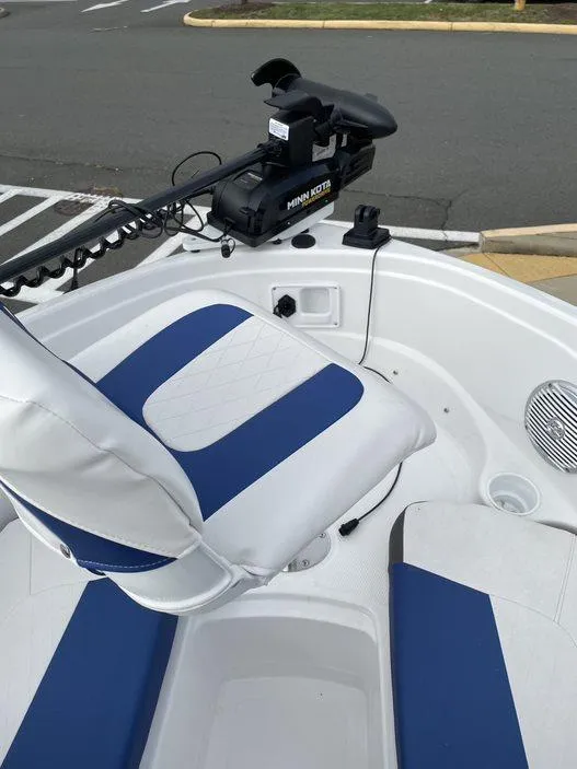 Slide: The Image of 2024 Tahoe 185 S boat with blue and white seating and Minn Kota trolling motor. - 5