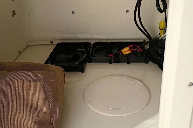 Slide: The Image of Interior view of 2026 Pioneer 180 Sportfish boat wiring and storage area. - 12