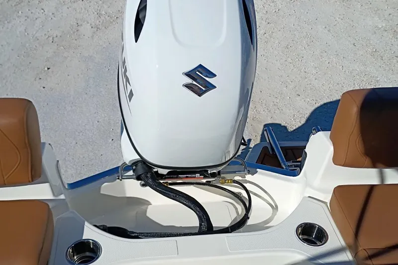 Slide: The Image of 2026 Pioneer 180 Sportfish boat with Suzuki outboard motor, brown seating, and cup holders. - 24