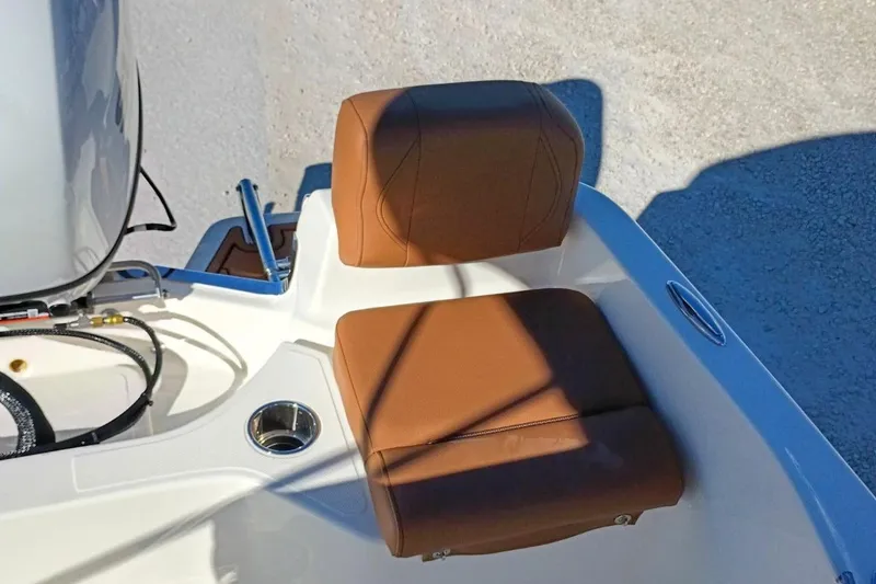 Slide: The Image of Brown seat on 2026 Pioneer 180 Sportfish boat, featuring cup holder and sleek design. - 26
