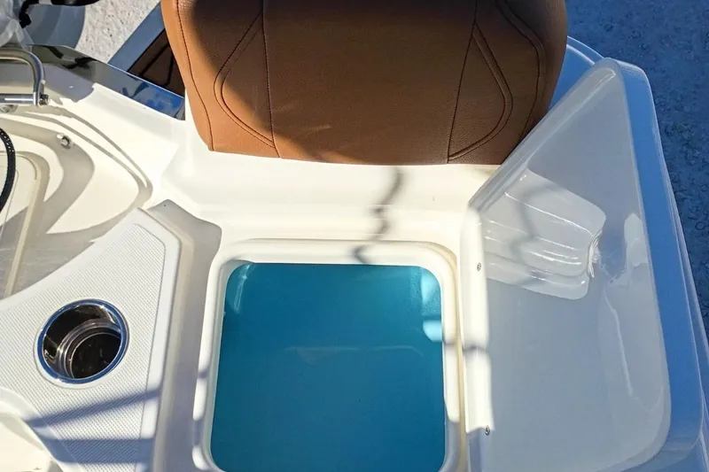Slide: The Image of 2026 Pioneer 180 Sportfish boat interior with tan seat and blue compartment. - 28