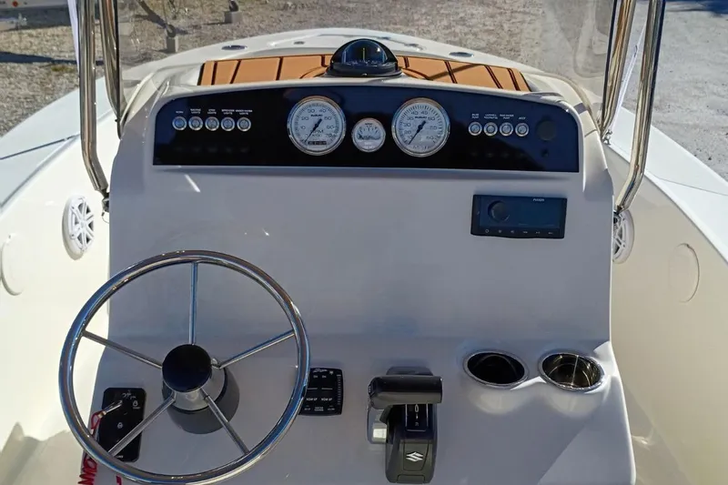 Slide: The Image of Control panel of 2026 Pioneer 180 Sportfish boat with steering wheel and gauges. - 4