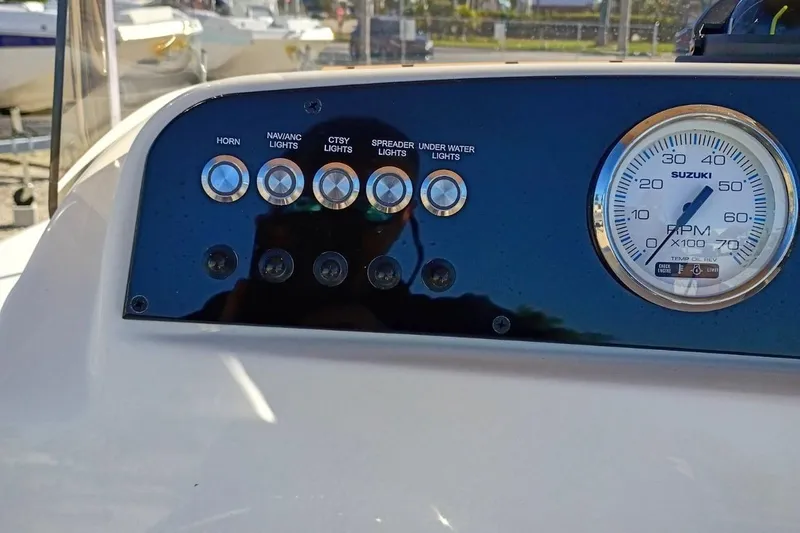 Slide: The Image of Dashboard of 2026 Pioneer 180 Sportfish boat with control switches and RPM gauge. - 8