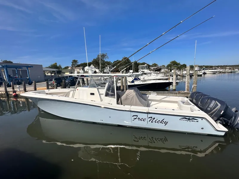The Image of 2017 Invincible 42 Center Cabin boat docked at marina. - 0