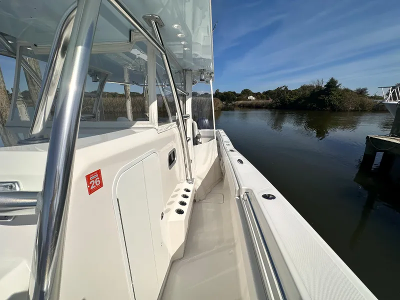 Slide: The Image of 2017 Invincible 42 Center Cabin boat docked by a serene waterway. - 15