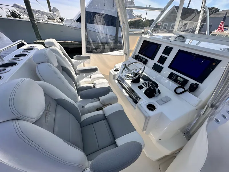 Slide: The Image of 2017 Invincible 42 Center Cabin boat interior with modern helm and seating. - 17