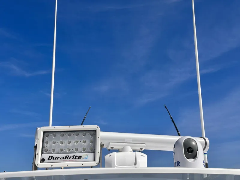 Slide: The Image of 2017 Invincible 42 Center Cabin with DuraBrite light and radar against blue sky - 19