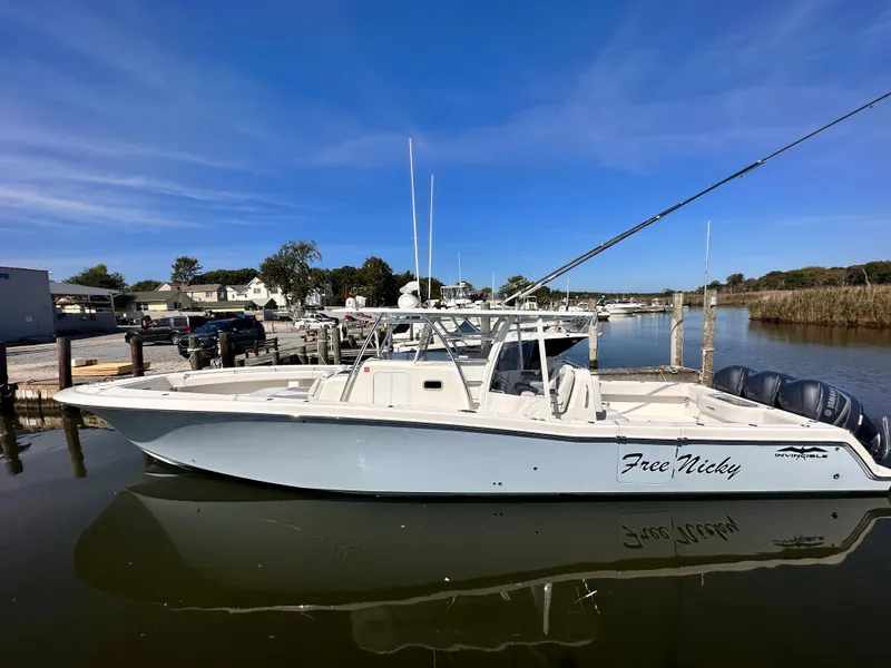 Slide: The Image of 2017 Invincible 42 Center Cabin boat docked in a marina. - 2