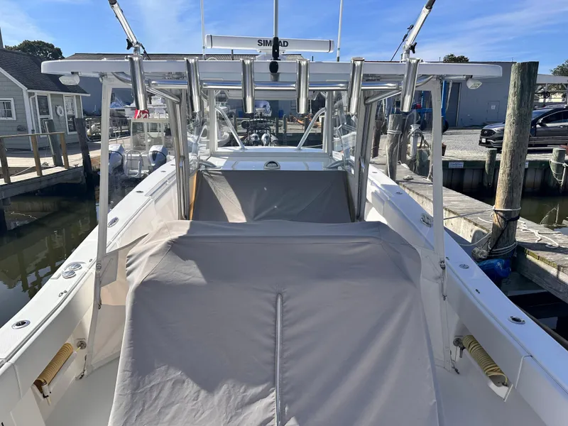 Slide: The Image of 2017 Invincible 42 Center Cabin boat docked at a marina. - 24