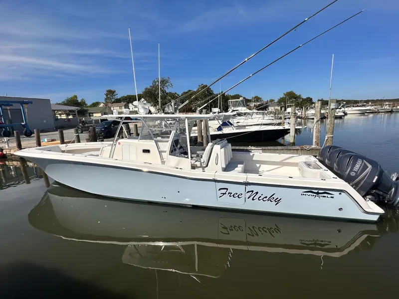 Slide: The Image of 2017 Invincible 42 Center Cabin boat docked in a marina. - 3
