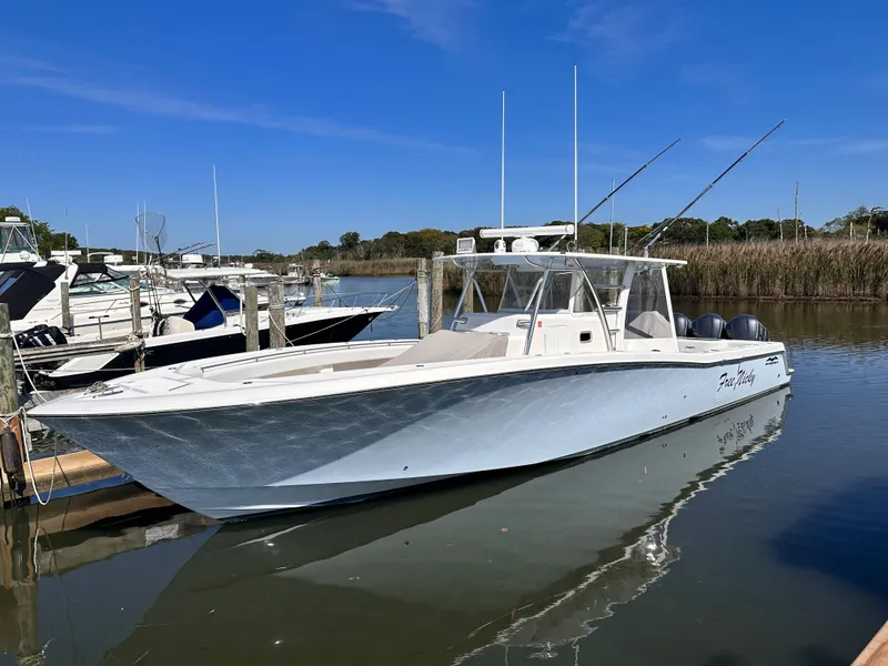 Slide: The Image of 2017 Invincible 42 Center Cabin boat docked in a marina on a sunny day. - 4