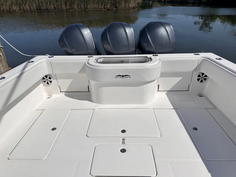 Slide: The Image of 2017 Invincible 42 Center Cabin boat with triple outboard engines. - 6