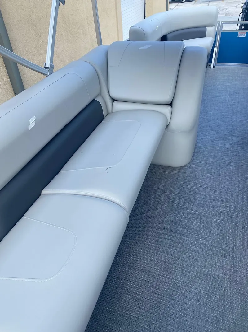 Slide: The Image of 2024 Starcraft LX 20 R pontoon boat with comfortable seating and modern design. - 10