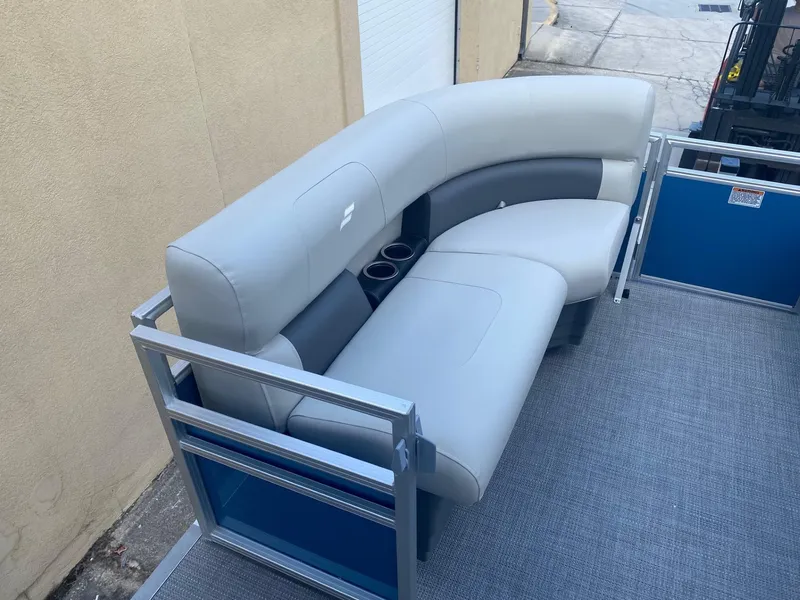 Slide: The Image of 2024 Starcraft LX 20 R pontoon boat with gray seating and cup holders. - 16