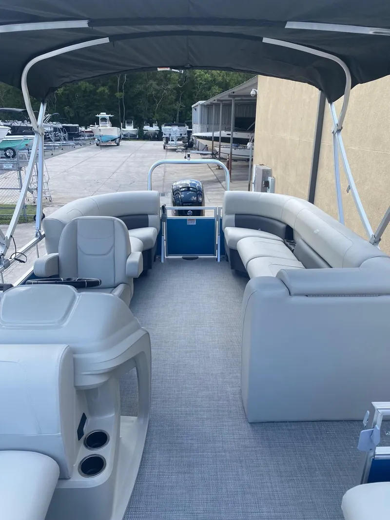 Slide: The Image of 2024 Starcraft LX 20 R pontoon boat with spacious seating and canopy. - 18