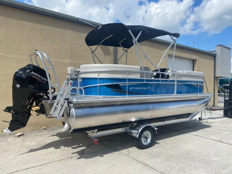 Slide: The Image of 2024 Starcraft LX 20 R pontoon boat with Mercury outboard motor. - 3