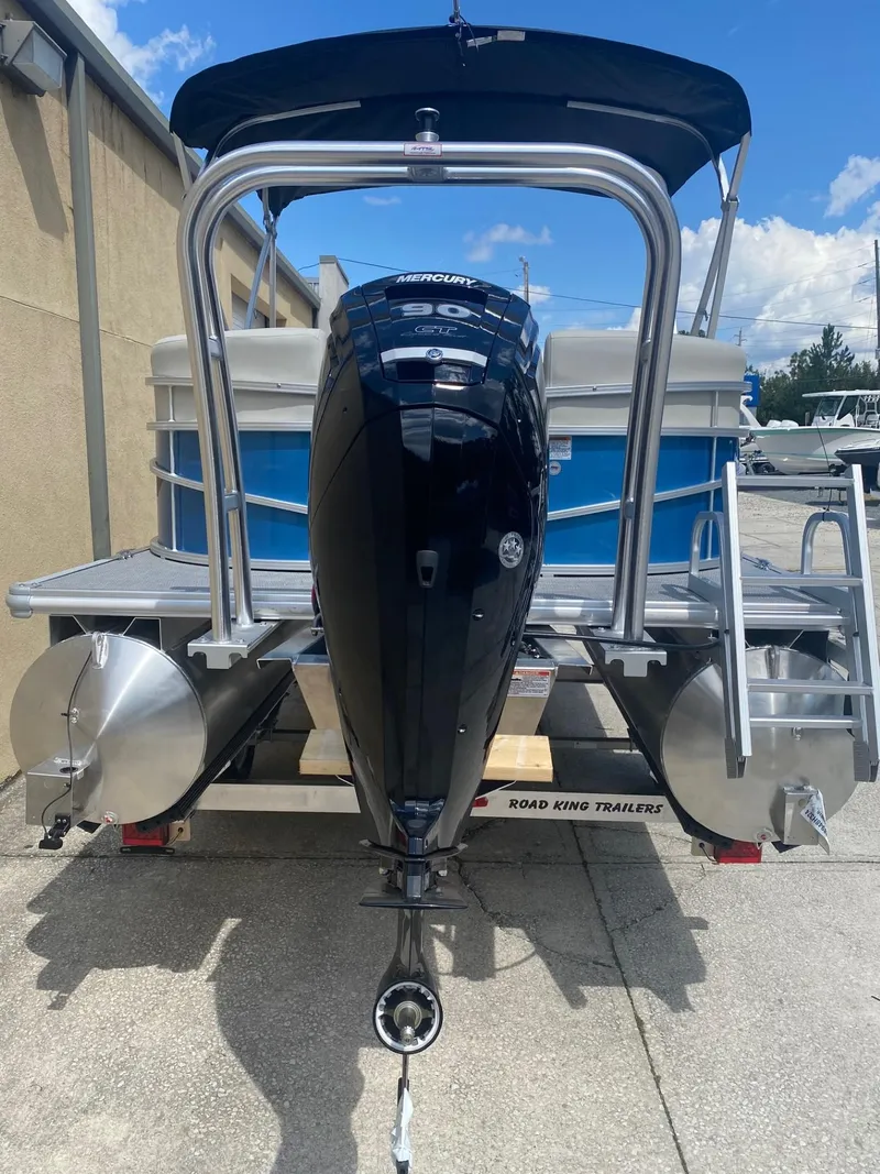 Slide: The Image of 2024 Starcraft LX 20 R pontoon boat with outboard motor on trailer. - 4