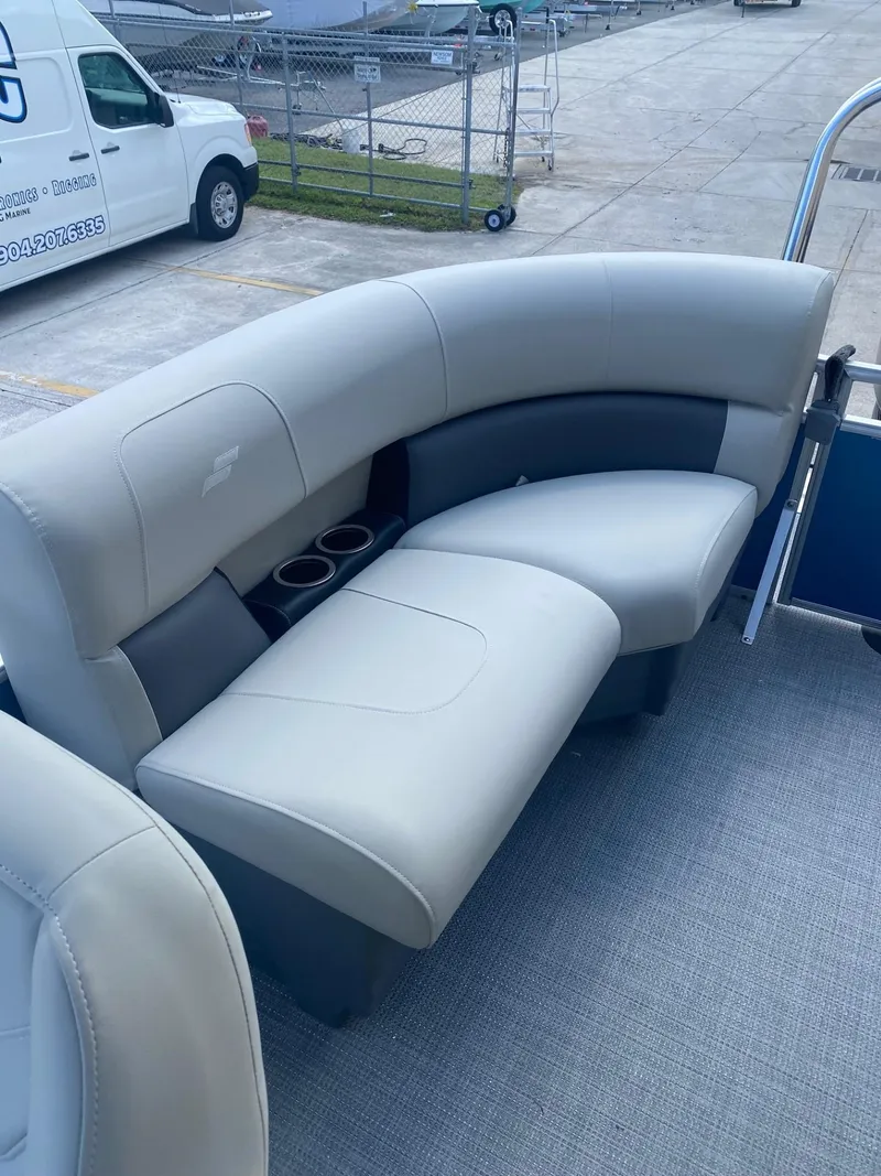 Slide: The Image of 2024 Starcraft LX 20 R pontoon boat with plush seating and cup holders. - 7