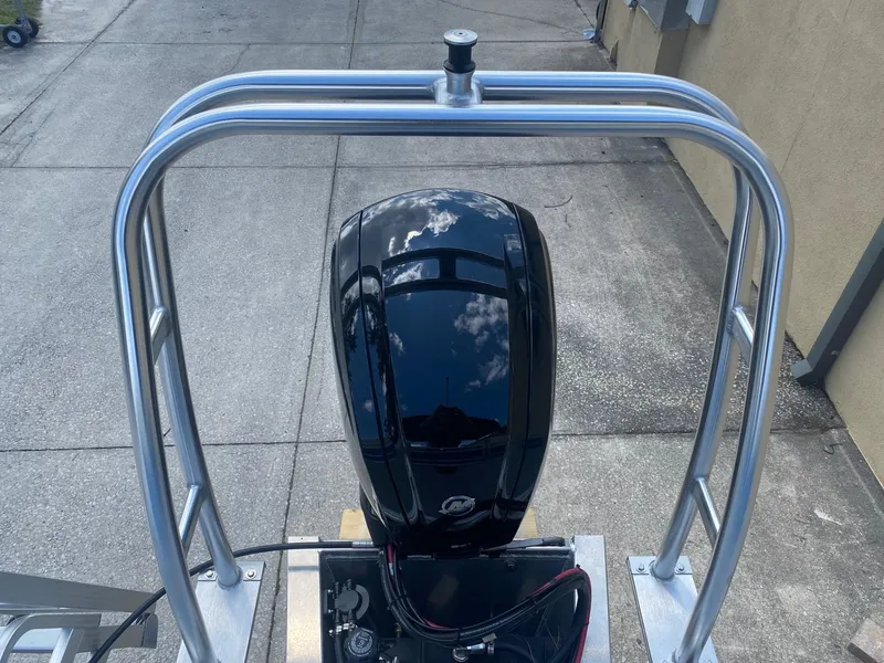 Slide: The Image of 2024 Starcraft LX 20 R boat engine and rear frame on a concrete surface. - 8