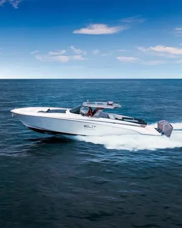 Slide: The Image of 2023 Canados 493 Gladiator cruising on open sea under clear blue sky. - 0