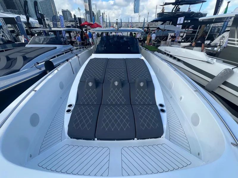 Slide: The Image of 2023 Canados 493 Gladiator luxury yacht with sleek design and spacious deck at a boat show. - 16