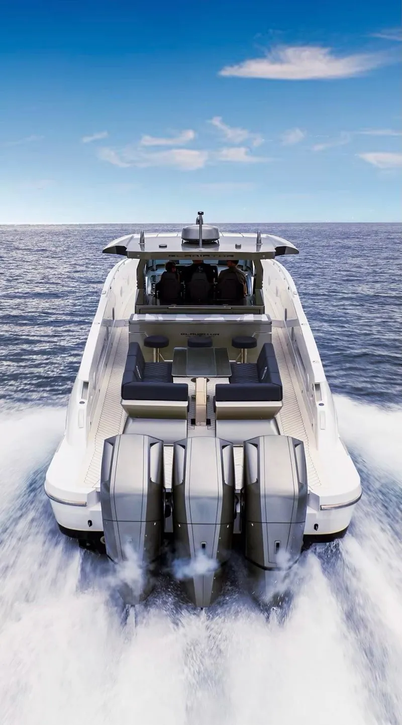 Slide: The Image of 2023 Canados 493 Gladiator yacht cruising on open water, rear view. - 2