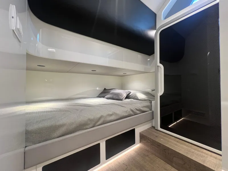 Slide: The Image of 2023 Canados 493 Gladiator cabin interior with modern bed and sleek design. - 25
