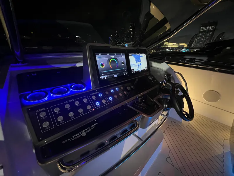 Slide: The Image of 2023 Canados 493 Gladiator yacht cockpit with illuminated control panel and navigation screens. - 28
