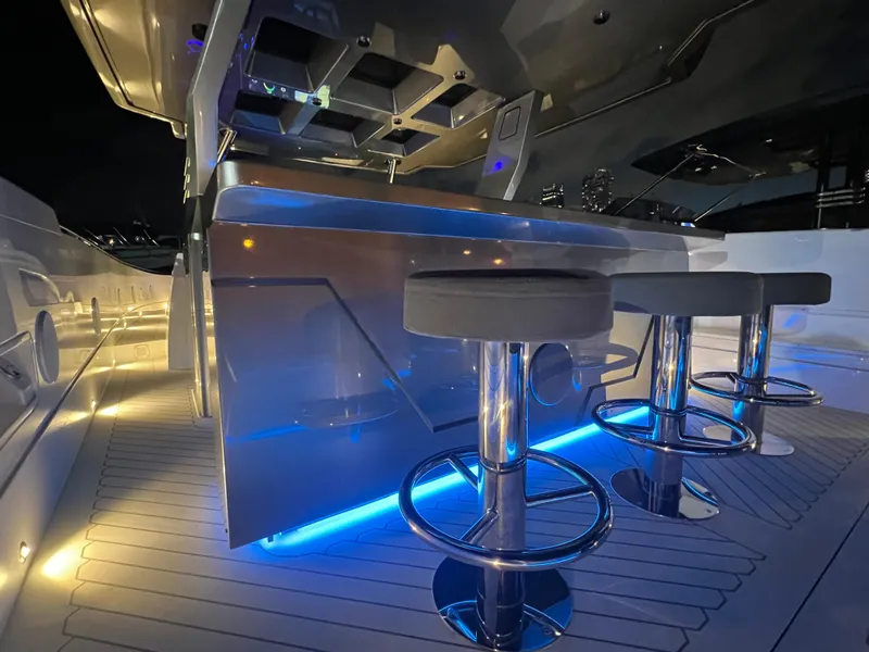 Slide: The Image of 2023 Canados 493 Gladiator yacht interior with illuminated bar and modern stools. - 29