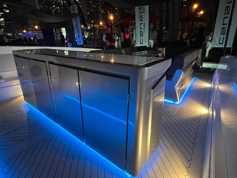 Slide: The Image of 2023 Canados 493 Gladiator yacht interior with sleek design and ambient blue lighting. - 30