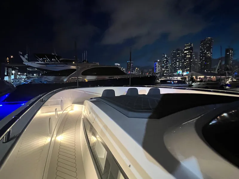 Slide: The Image of 2023 Canados 493 Gladiator yacht docked at night with city skyline in background. - 42