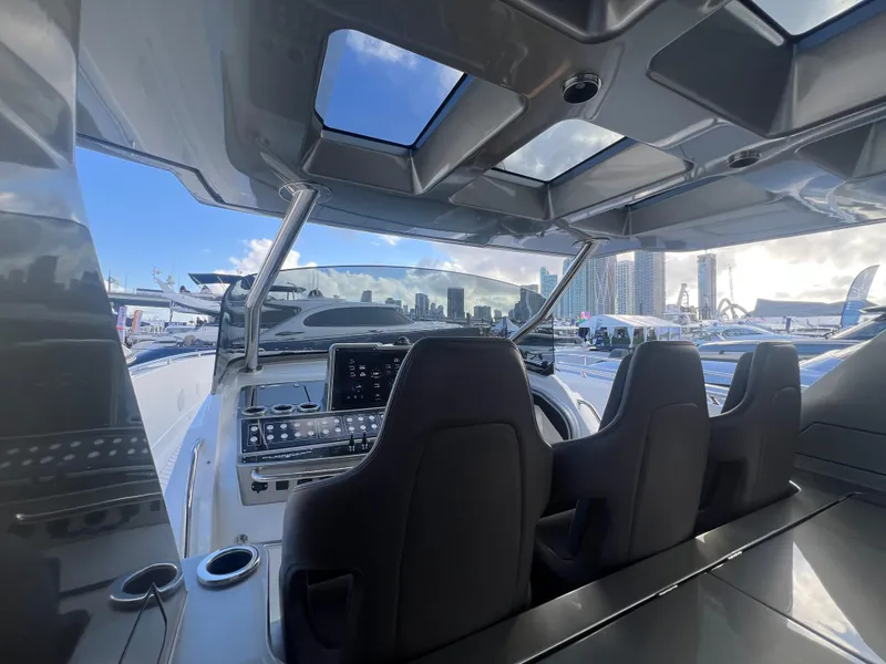 Slide: The Image of 2023 Canados 493 Gladiator yacht cockpit with modern controls and panoramic city skyline view. - 43