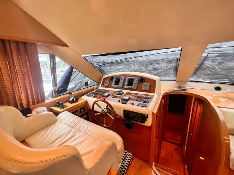 Slide: The Image of Interior helm of 2001 Uniesse Flybridge 48 yacht with leather captain's chair. - 10