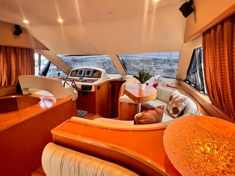Slide: The Image of Luxurious interior of 2001 Uniesse Flybridge 48 yacht with plush seating and elegant decor. - 11
