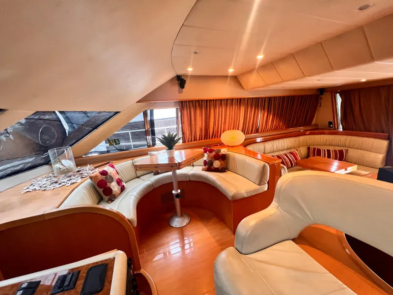 Slide: The Image of Luxurious interior of a 2001 Uniesse Flybridge 48 yacht with plush seating and elegant decor. - 12